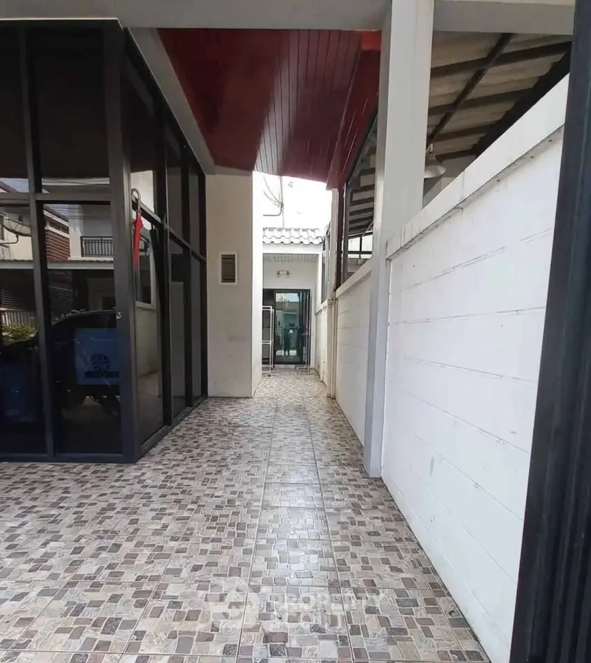 Modern exterior corridor with tiled flooring and glass facade in contemporary building.