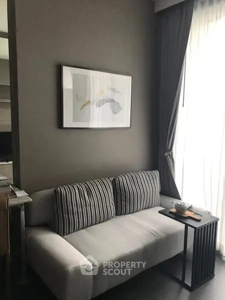 Cozy living room with modern sofa and stylish wall art, perfect for relaxation.