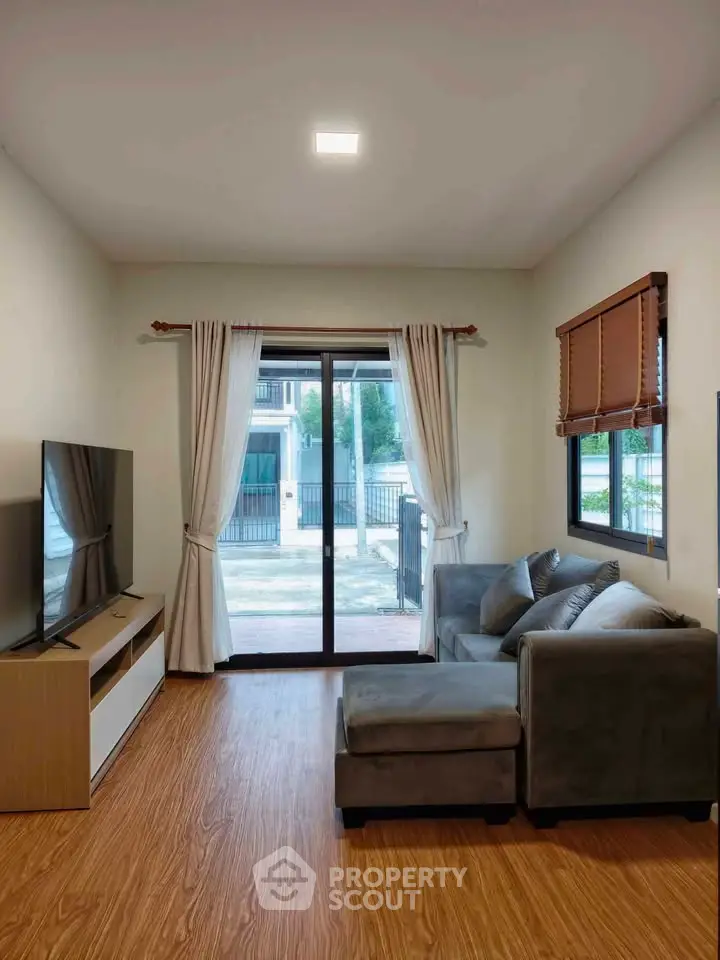 Modern living room with large window and cozy sofa in a stylish apartment