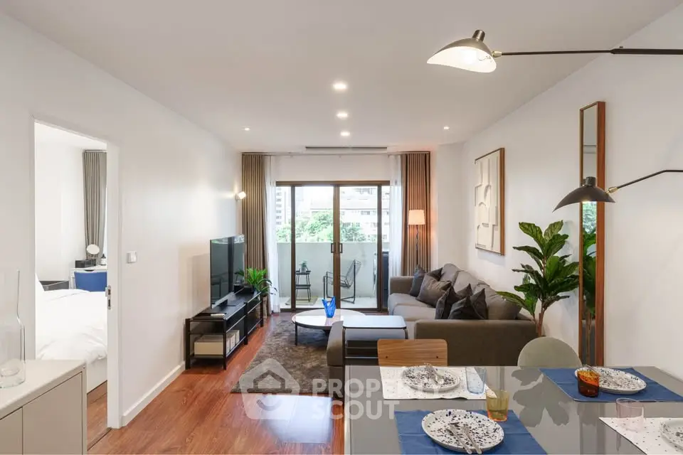 Modern living room with stylish decor and balcony view in a contemporary apartment.