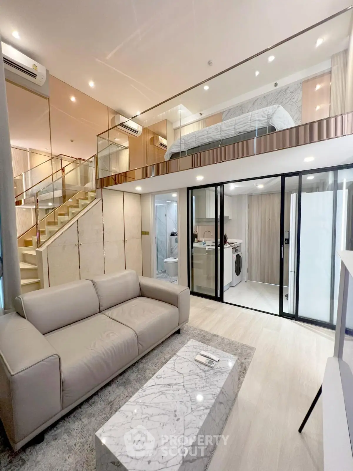 Modern loft apartment with stylish living area and mezzanine bedroom, featuring sleek design and luxurious finishes.