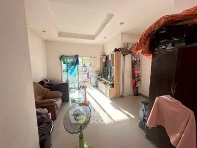 Cozy living room with natural light and comfortable seating area.