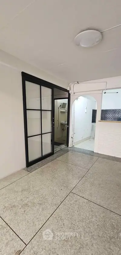 Spacious interior with sliding glass doors and open layout, ideal for modern living.