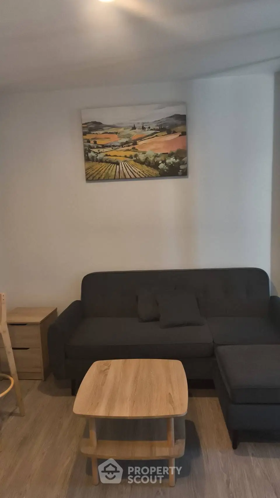 Cozy living room with modern sofa and wooden coffee table, perfect for relaxation.