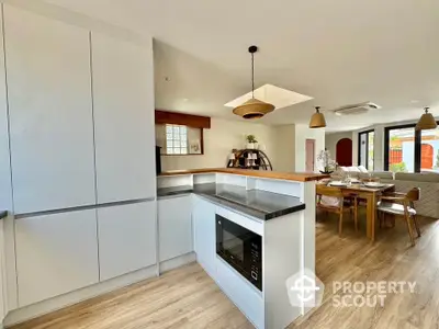 Modern open-plan kitchen and living area with stylish decor and natural light.