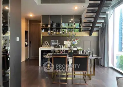 Luxurious modern dining area with stylish staircase and elegant decor in a high-end apartment.