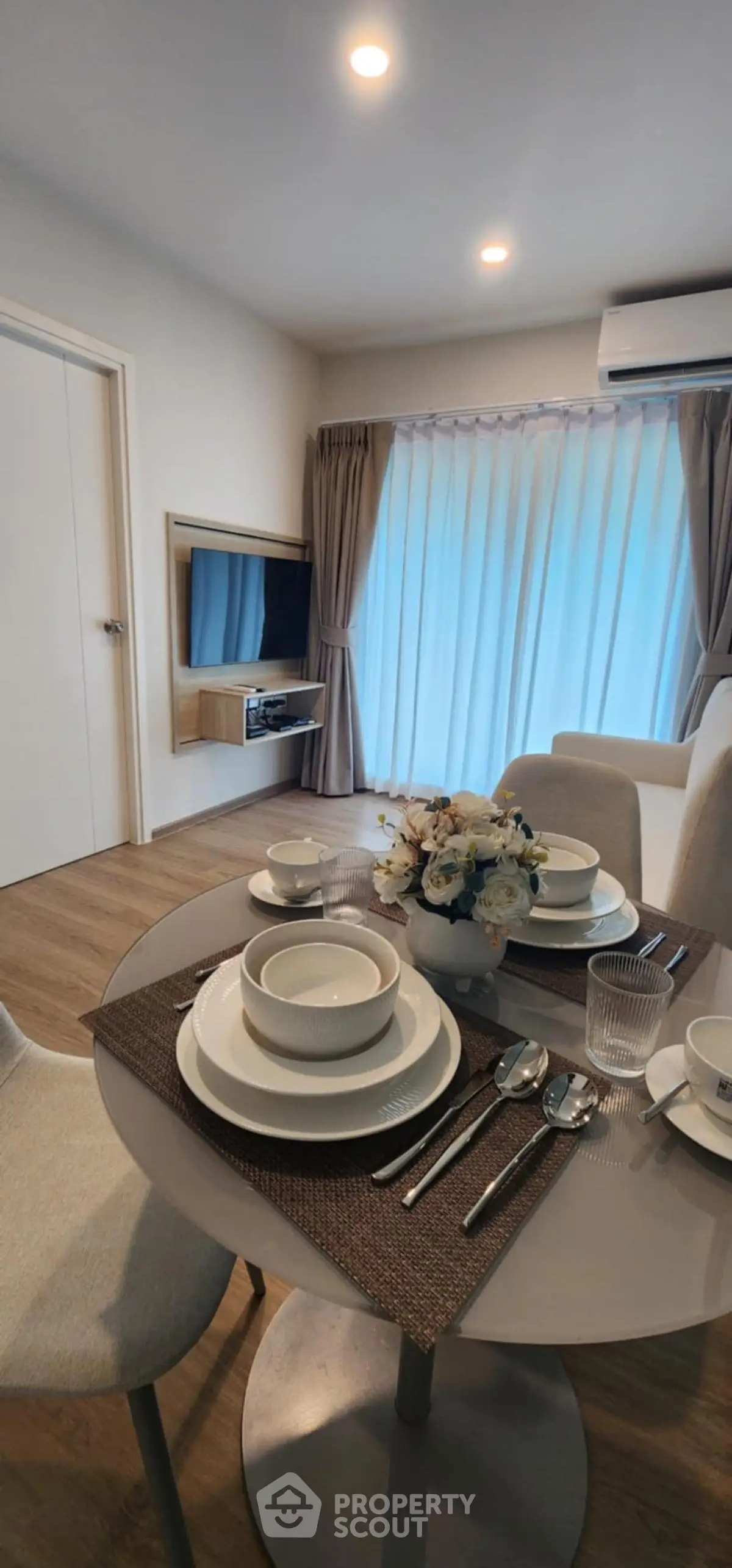 Modern dining area with elegant table setting and cozy living room ambiance