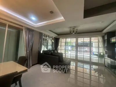 Spacious living room with modern decor and large windows for natural light.