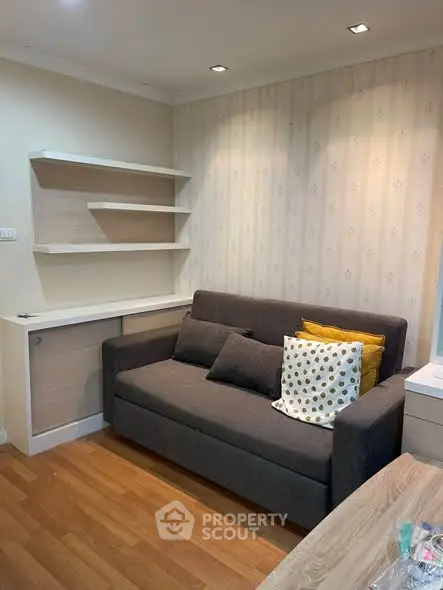 Cozy living room with modern sofa and stylish shelving, perfect for relaxation and entertaining.