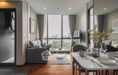 Modern living room with city view, elegant decor, and dining area in a high-rise apartment.