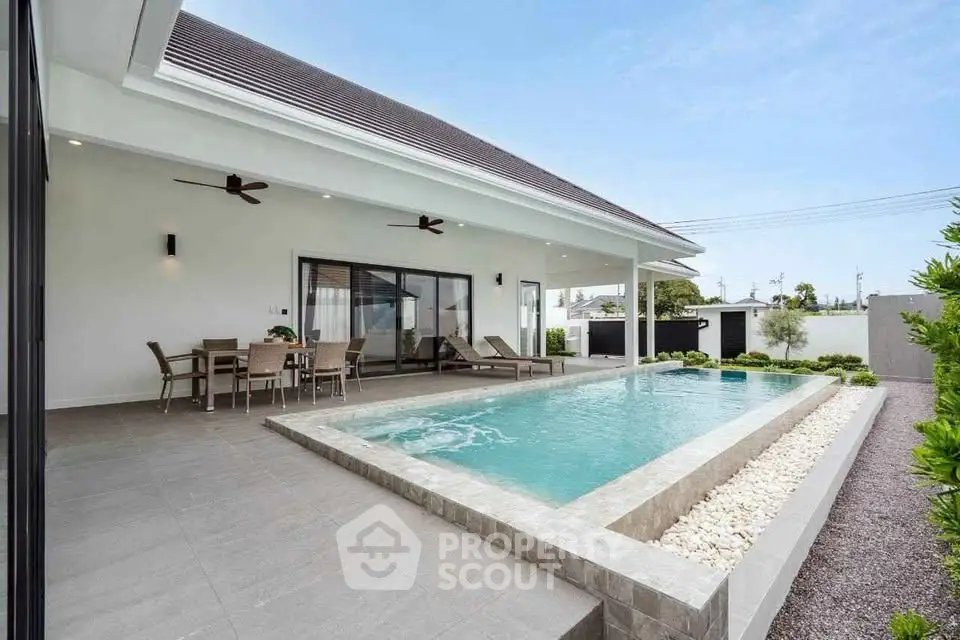 Luxurious modern villa with private pool and spacious patio, perfect for outdoor entertaining.