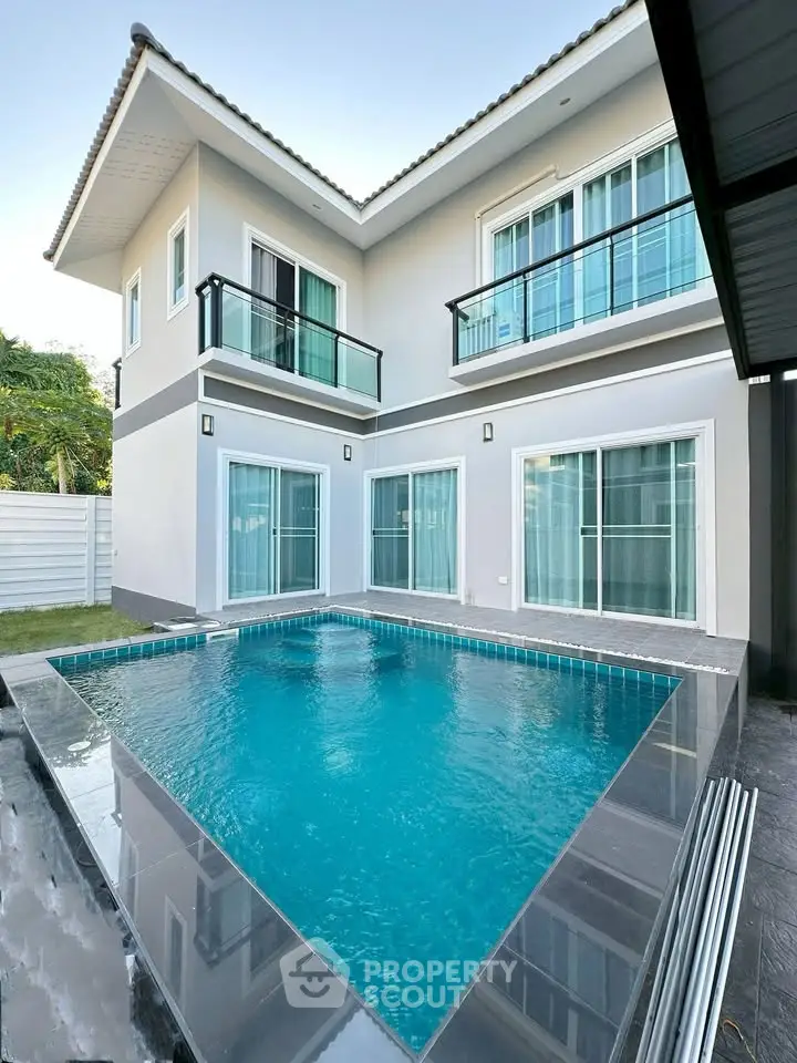Modern two-story house with private pool and sleek balcony design.