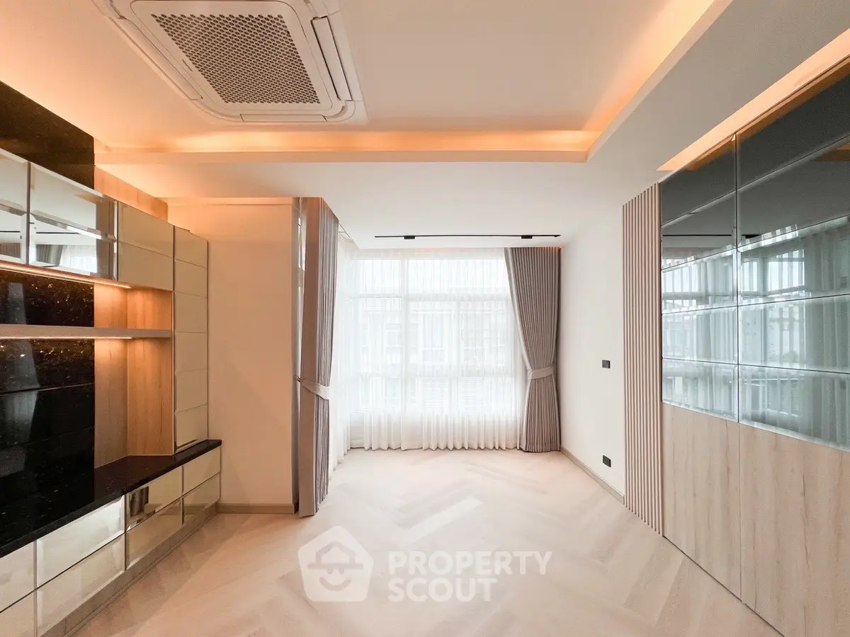 Spacious modern living room with elegant lighting and large windows