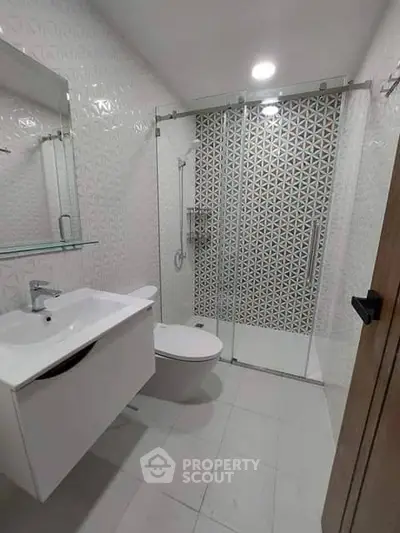 Modern bathroom with sleek fixtures and geometric tile design