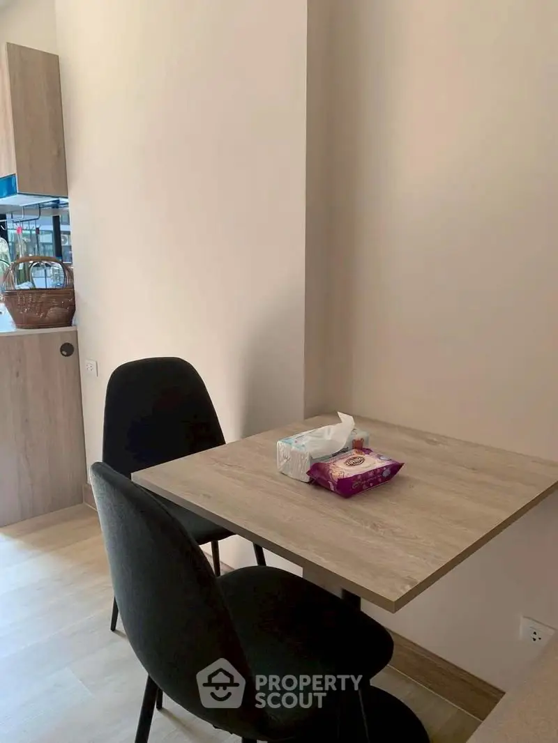 Cozy dining nook with modern chairs and wooden table in a stylish apartment.