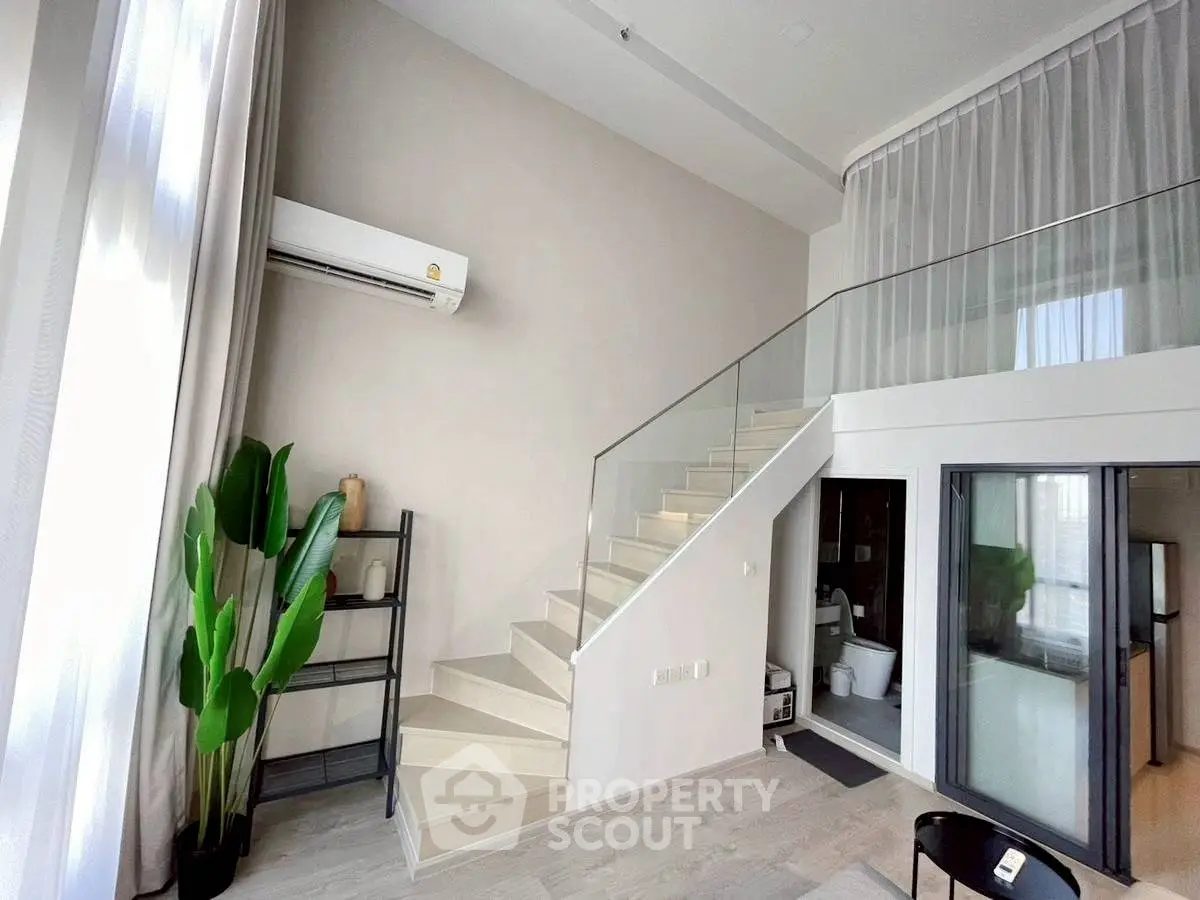 Modern duplex apartment with stylish staircase and large windows