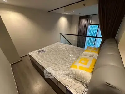 Modern bedroom with large bed and floor-to-ceiling window in stylish apartment.
