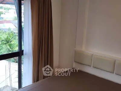 Cozy bedroom with large window and elegant curtains