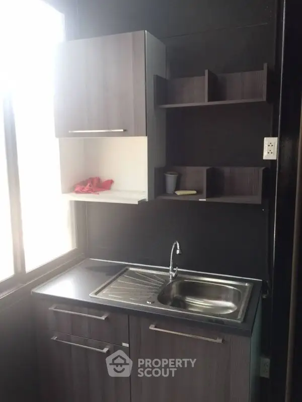 Compact modern kitchen with sleek cabinetry and stainless steel sink