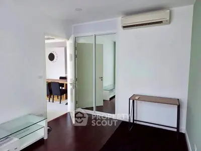Modern interior with glass door, air conditioning, and sleek furniture in a stylish apartment.