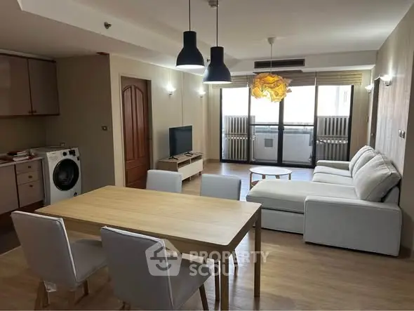 Spacious modern living room with open kitchen and stylish furniture in a bright apartment.