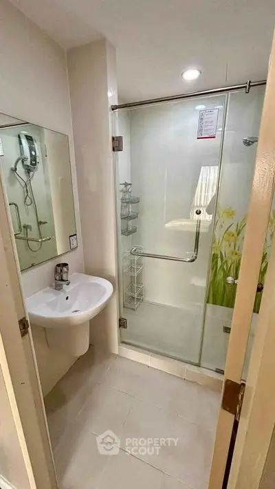 Modern bathroom with glass shower enclosure and sleek fixtures
