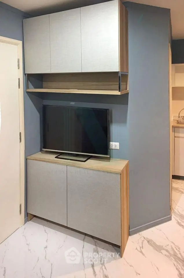 Modern living room with sleek TV cabinet and marble flooring