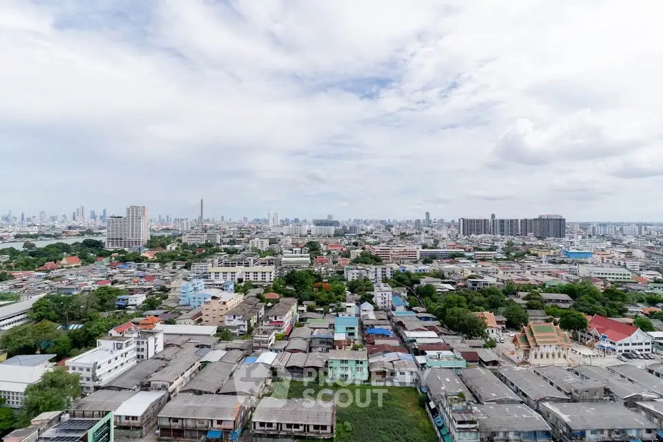 Stunning panoramic cityscape view showcasing urban skyline and residential buildings under a clear sky.