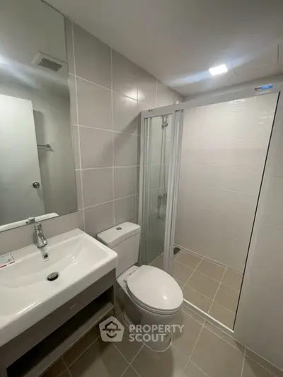 Modern bathroom with sleek fixtures and glass shower enclosure