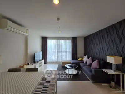 Spacious modern living room with stylish decor and large window view