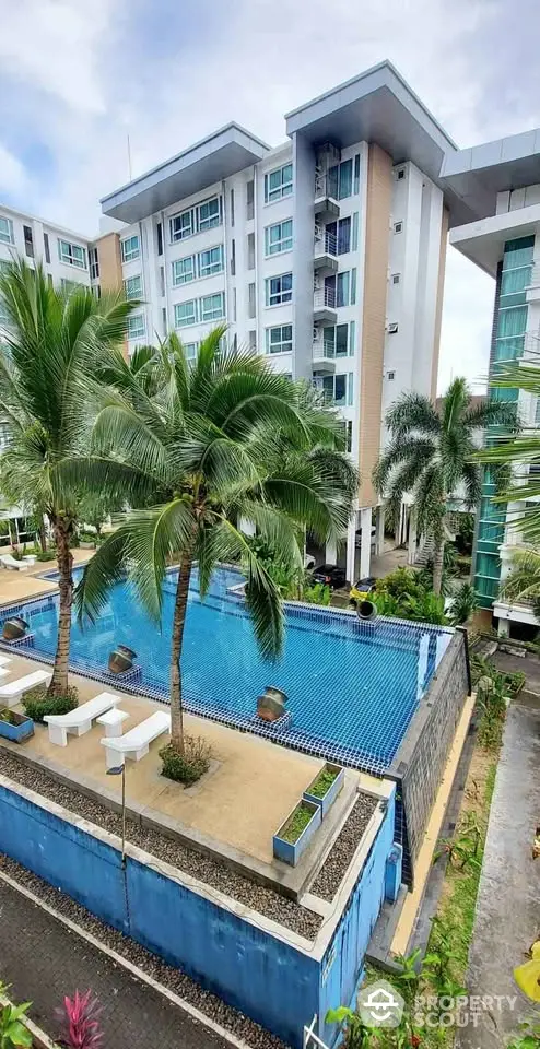 Luxurious condominium with pool and palm trees offering resort-style living