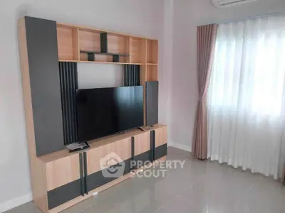 Modern living room with sleek TV stand and natural light