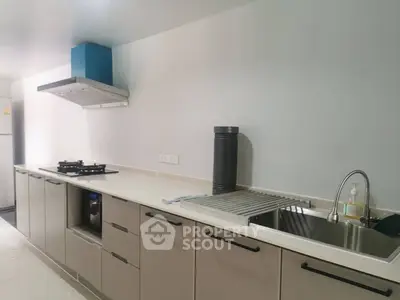 Modern kitchen with sleek cabinetry and gas stove