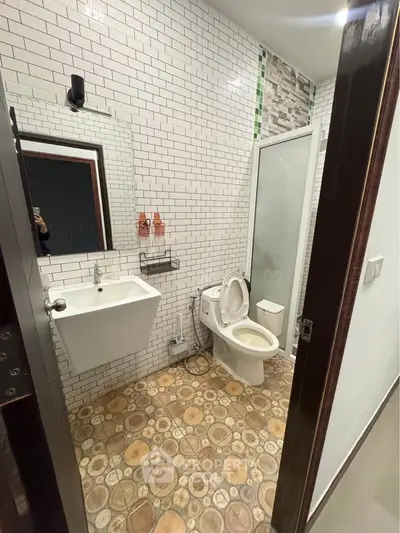 Modern bathroom with white subway tiles and stylish flooring