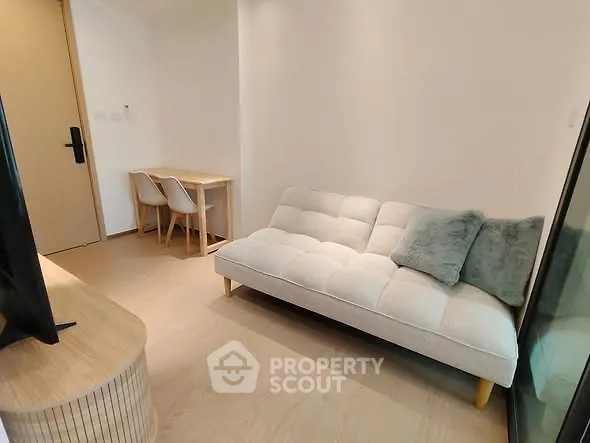 Modern living room with cozy sofa and dining area in stylish apartment.