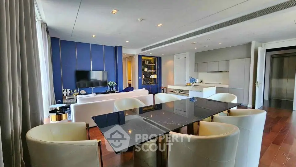 Luxurious modern living room with elegant dining area and sleek kitchen in open layout.