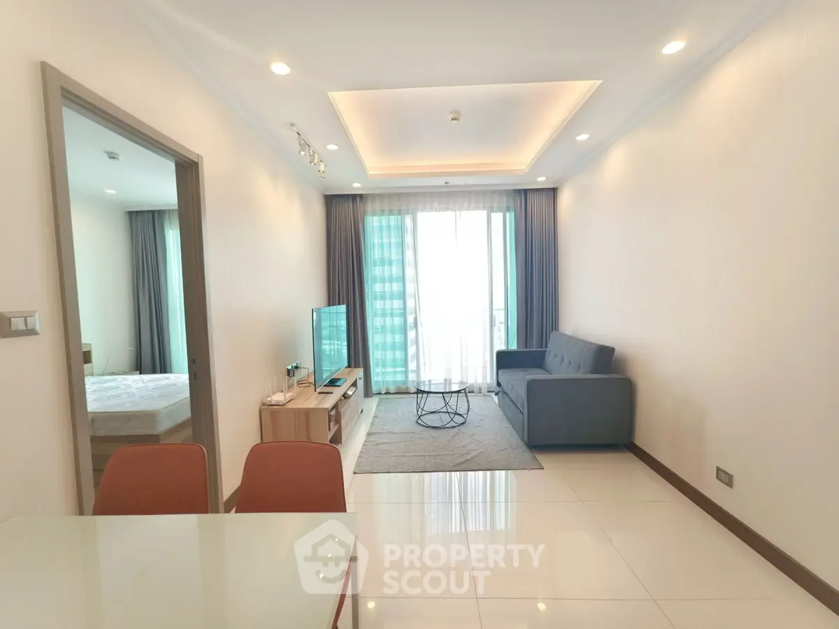 Modern living room with sleek furniture and natural light in a stylish apartment.