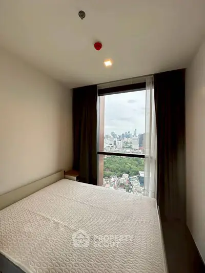Spacious bedroom with stunning city view in modern high-rise apartment.