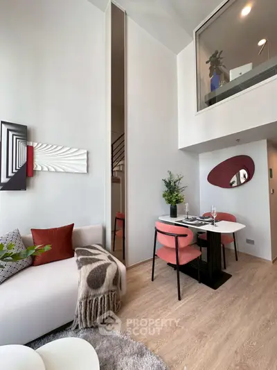 Modern duplex living room with stylish decor and cozy dining area