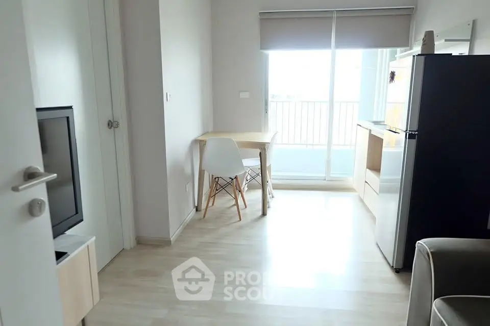 Bright modern living room with balcony access and sleek furniture