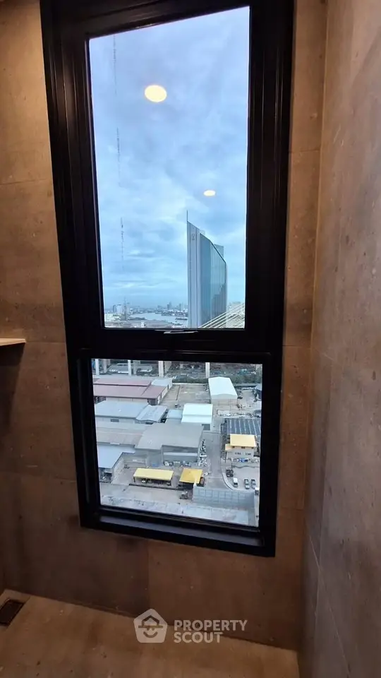 Stunning cityscape view from a modern high-rise window, showcasing urban architecture and skyline.