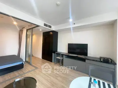 Modern studio apartment with sleek furnishings and open layout, featuring a cozy bedroom and stylish living area.