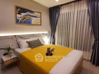 Cozy bedroom with modern decor, featuring a plush bed, elegant curtains, and stylish artwork, perfect for relaxation.