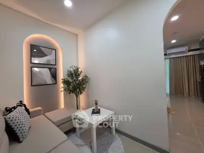 Modern living room with stylish decor and cozy seating area, perfect for relaxation.