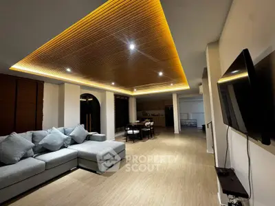 Spacious modern living room with stylish ceiling lights and open layout, perfect for entertaining.