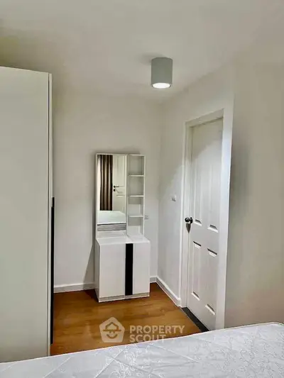 Modern bedroom with minimalist decor and sleek furniture in a bright, cozy apartment.