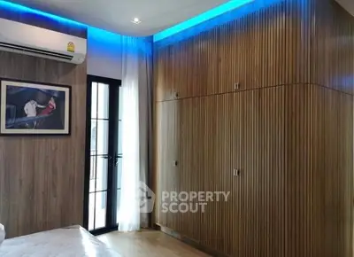 Modern bedroom with wooden paneling and ambient lighting