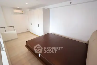 Spacious bedroom with modern design and ample storage in a stylish apartment.