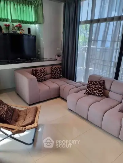 Cozy living room with modern sofas and large windows for natural light