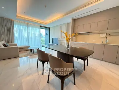 Luxurious open-plan living room and kitchen with modern furnishings and elegant lighting.